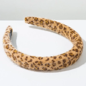 Detail shot of the plush leopard print headband showing soft faux fur texture and thickness