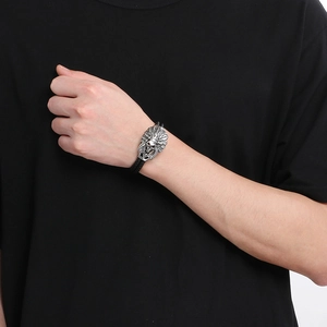 Men's braided leather bracelet with stainless steel Indian skull charm on model's wrist