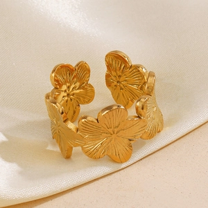 Vintage gold hollow flower open ring in brushed stainless steel on white silk
