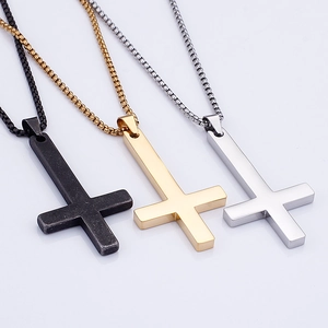 Three upside-down cross necklaces in black, gold, and silver finishes with box chains