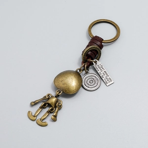 Porte-clés vintage en bronze avec pendentif squelette robot et cuir tressé marron