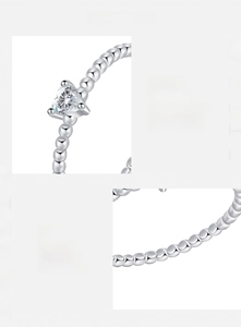 Detail of s925 silver beaded ring featuring a heart-shaped D color VVS1 moissanite stone