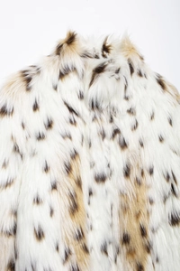 Detail of the soft faux fur collar and back texture on a white leopard print coat