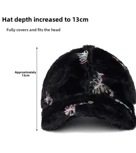 Detail of 13cm deep black plush baseball cap showing fluffy texture and feather embroidery
