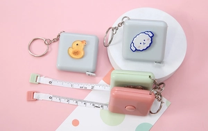 Mini retractable cartoon tape measure keychain showing 150cm dual scale and cute designs