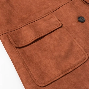 Close-up of brown suede jacket pocket with fine stitching and dark button details
