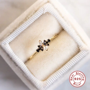 Detail of luxury S925 sterling silver ring with marquise opal in a velvet box