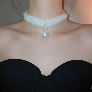 Detail of elegant white faux fur choker with a large teardrop pearl pendant for women