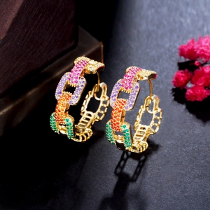 Macro shot of gold hoop earrings with multi-colored gradient zircon chain design