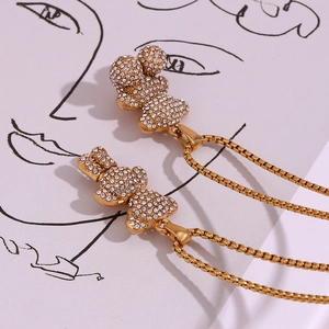 Macro detail of 18K gold plated bear pendant with sparkling white cubic zirconia