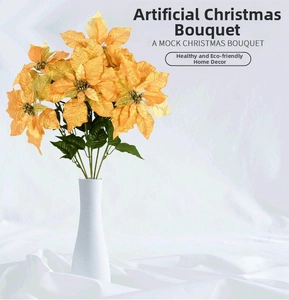 Detail of yellow Christmas poinsettia flowers with golden beads in a white ceramic vase
