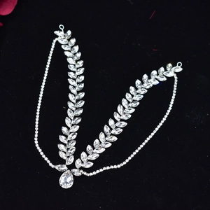 Detailed view of silver bridal headpiece with crystal rhinestones and teardrop pendant