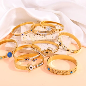 Detailed view of gold titanium steel evil eye bracelets with blue enamel and rhinestones