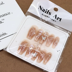 Handmade press-on nails with nude gradient, silver butterfly charms and pearl accents