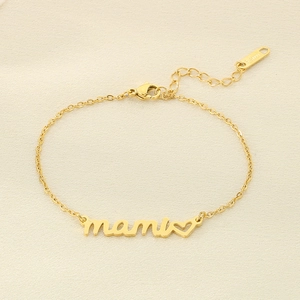 Detail of gold Mami bracelet with heart charm and S.STEEL material hallmark