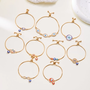 Adjustable gold evil eye bracelets featuring colorful enamel beads and Hamsa hand charms