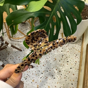 Classic leopard print semi-circle shark hair claw clip with glossy finish and logo