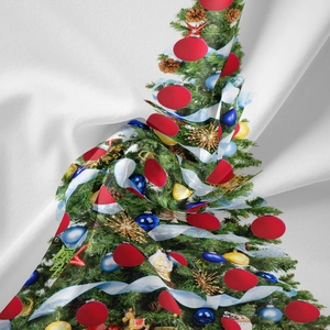 Detail of Christmas tree print on soft white fabric with ornaments and natural folds