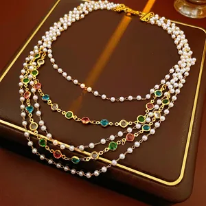 Vintage multilayer pearl necklace with colorful gemstones on leather background