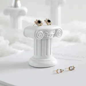 French vintage style earrings with pearls and black gems on elegant white props
