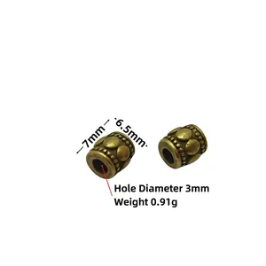 Detail of vintage bronze barrel beads with dot relief patterns for DIY jewelry