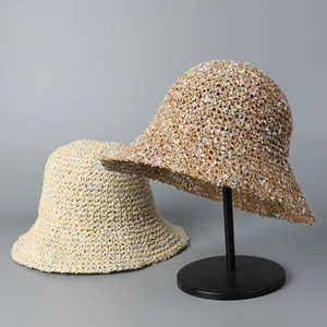 Detailed texture of colorful hand-crocheted women's summer straw sun hat on a stand