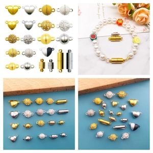 Macro view of various heart and sphere magnetic jewelry clasps on pearl bracelets