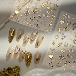 Luxury gold 3D nail art stickers with surrealist melting clocks and starburst designs