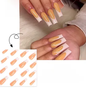 Detailed view of long coffin-shaped French press-on nails in orange and cream white colors