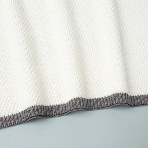 Detailed macro view of waffle knit fabric and ribbed dark grey edge trim