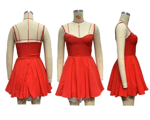 Detail view of red mini dress with white lace trim and puffy A-line silhouette