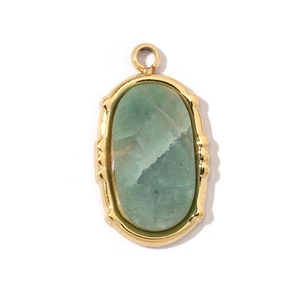Detailed macro view of a green oval gemstone pendant with polished gold titanium frame