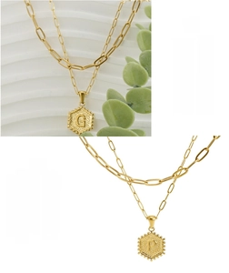 Detail of 18K gold stainless steel layered necklace with hexagon alphabet G and P pendants