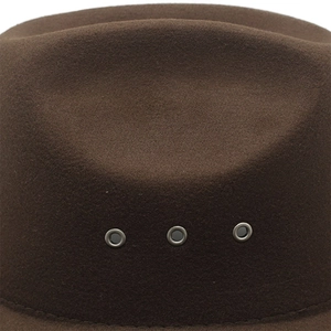 Close-up of three metal ventilation eyelets on a brown wool felt cowboy hat with stitching