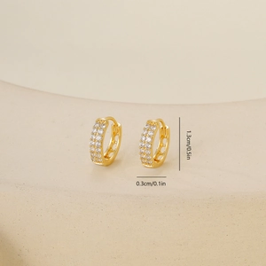 Detail view of gold zircon hoop earrings with 1.3cm height and 0.3cm width measurements