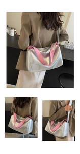 Detail of silver Boston bag with metallic finish and contrast pink shoulder strap