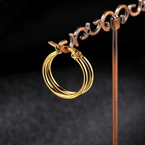 Macro shot of double layered gold titanium steel hoop earrings with high polish finish