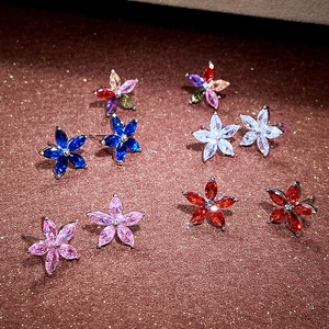 Macro detail of colorful five-petal flower stud earrings with marquise-cut zircon stones