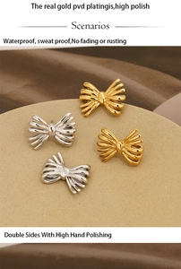 Detail of high polish PVD gold and silver bow earrings with waterproof metal surface
