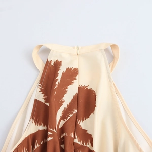 Halter neck maxi dress with coconut tree print and beige vacation style pattern