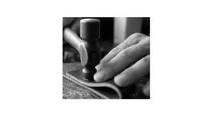 Close-up of hammer tool craftsmanship on premium PU leather strap for women belt