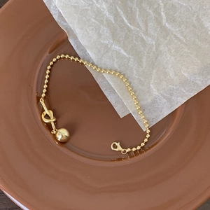 Minimalist S925 sterling silver beaded bracelet with heart charm on a ceramic plate