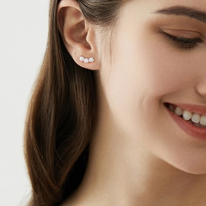 Three-stone minimalist silver earrings worn by model for a trendy and stylish look