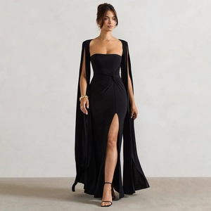 Detail of elegant square neck black gown featuring a high slit and cape sleeves