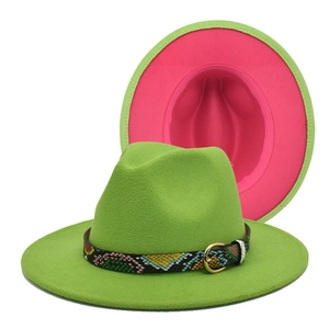 Detailed view of two-tone fedora hat in green and pink with snakeskin band and gold buckle