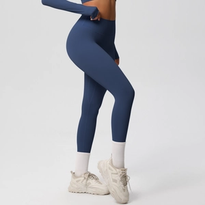 Detail of high-waist navy yoga leggings and long sleeve top with seamless stitching