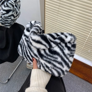 Chic black and white zebra print plush handbag with soft faux fur texture for women