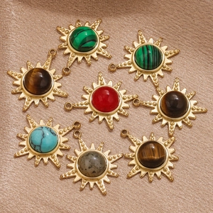 Golden sunburst star pendants with natural tiger eye and turquoise on silk fabric