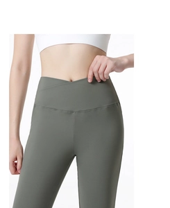 Detail of high-waisted yoga flare pants featuring a V-shaped crossover waistband design