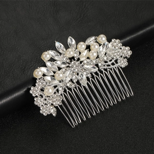 Silver bridal hair comb with pearls and rhinestones on black leather background